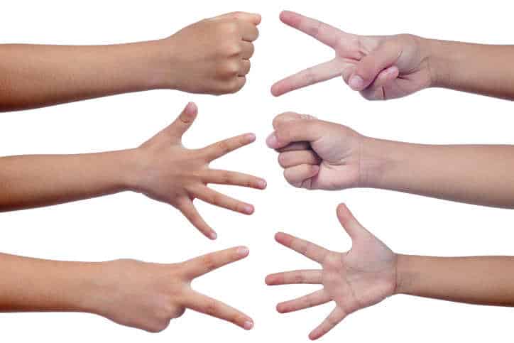 Child's hands making sign as rock paper and scissors