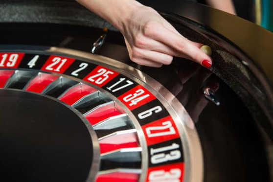 Roulette wheel with ball and hand