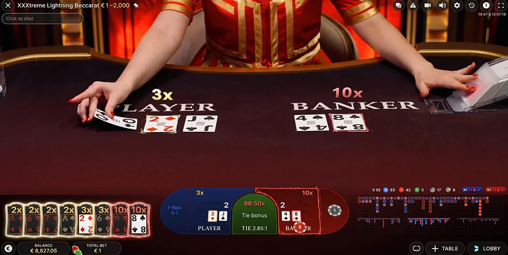 Live dealer distributing cards on the XXXtreme Baccarat table.